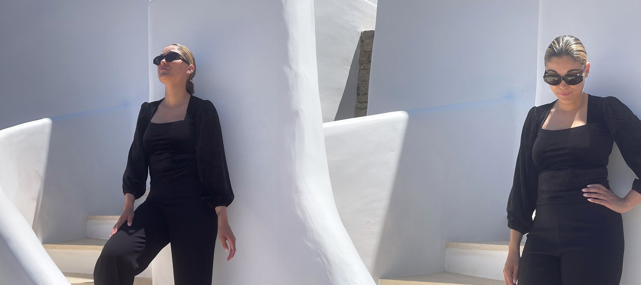 Woman in black outfit posing against a white architectural background