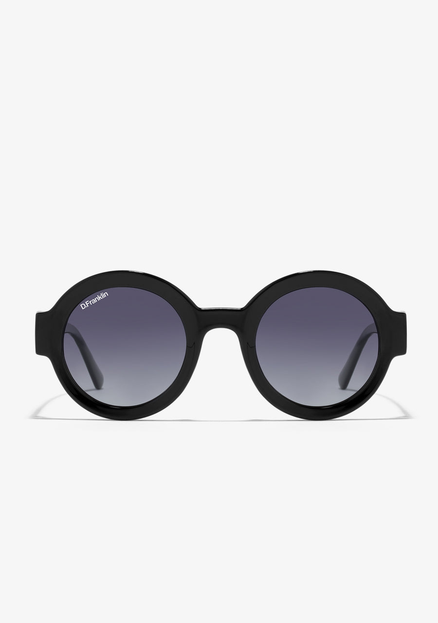 Round frame sunglasses with shiny black finish on the front frame and side temples, featuring gradient black lenses.
